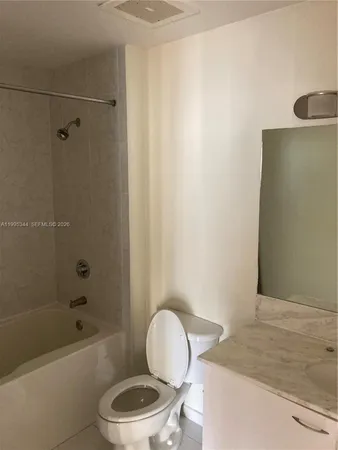a bathroom with a toilet a sink and bathtub