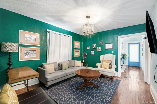 a living room with furniture a rug and a chandelier