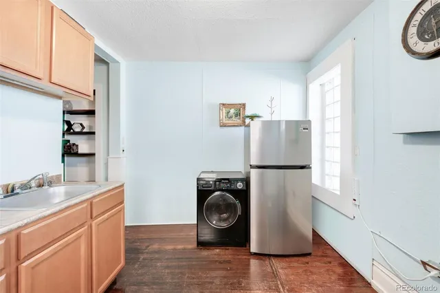 a utility room with sink dryer and washer