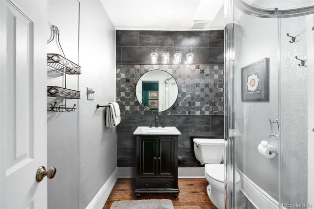 a bathroom with a toilet sink and shower