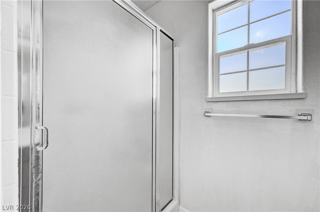 1272 Liston Avenue Logandale, NV 89021 - Photo 40 of 61 A well-lit shower enclosure with a clear window offers natural light in this tidy bathroom.