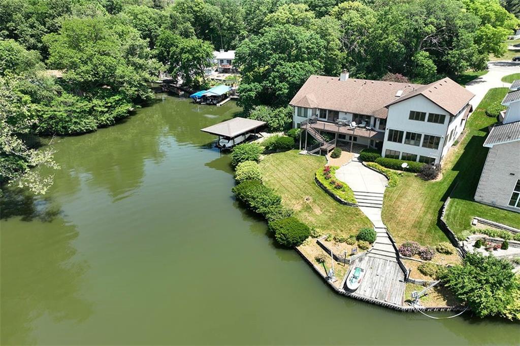 an aerial view of a house with outdoor space swimming pool and lake view