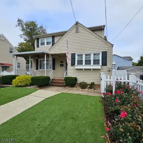 a front view of a house with a yard and potted plants
