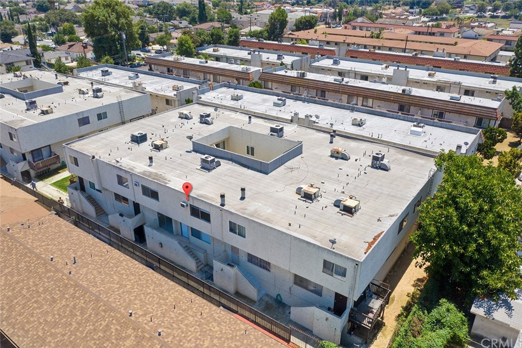 331 South New Avenue, Unit H Monterey Park, CA 91755 - Photo 22 of 26 a white building with swimming pool and lawn chairs