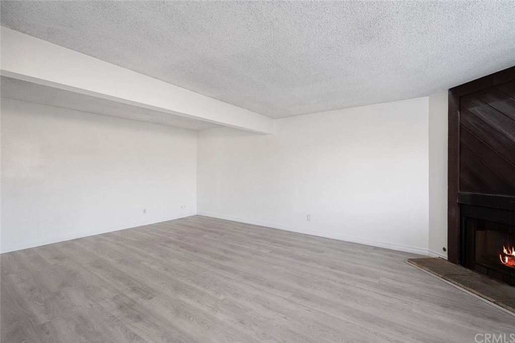 331 South New Avenue, Unit H Monterey Park, CA 91755 - Photo 3 of 26 a view of an empty room with wooden floor and a window