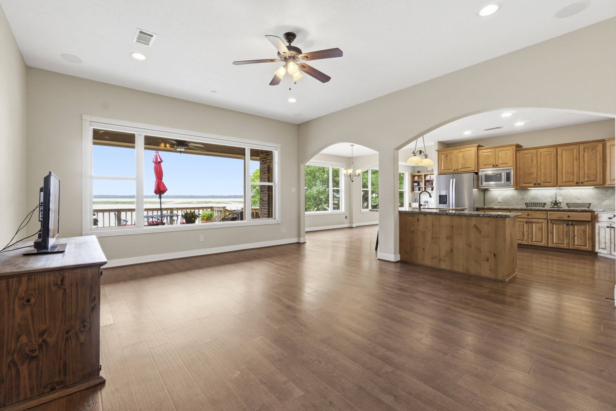259 Memphis Bell Lane Trinity, TX 75862 - Photo 4 of 50 a living room with stainless steel appliances kitchen island granite countertop a stove and a large window