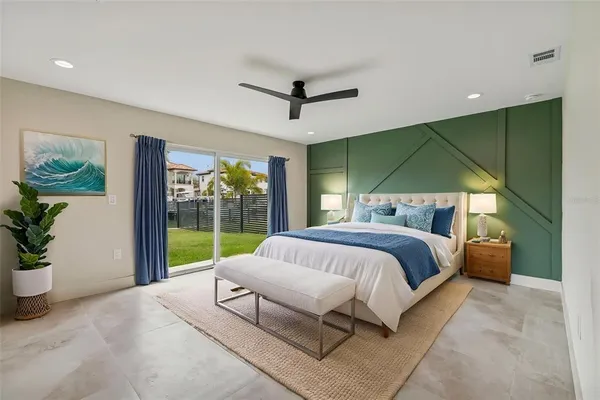 a bed sitting in a spacious bedroom next to a window