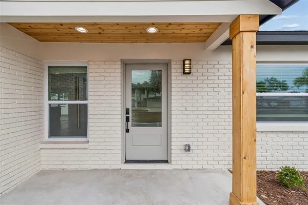 a view of front door and potted plants