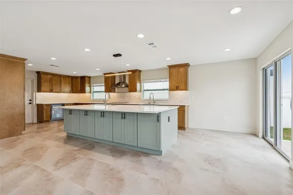 a large kitchen with stainless steel appliances granite countertop a large counter top and a stove