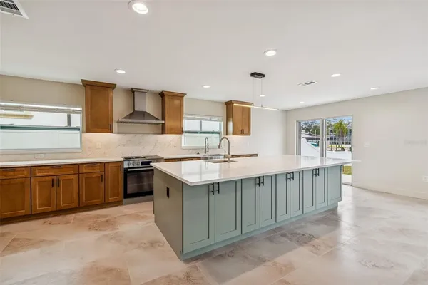 a kitchen with stainless steel appliances granite countertop a sink stove and cabinets