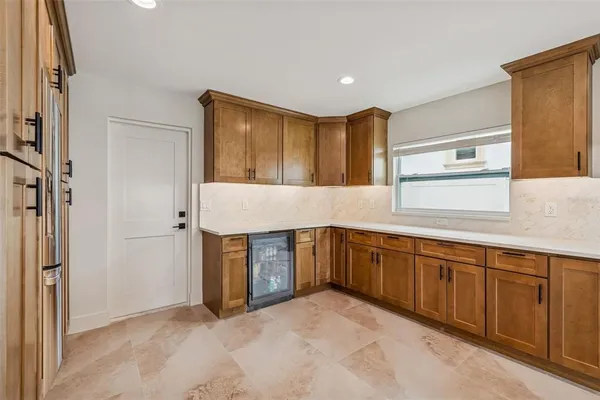 a kitchen with stainless steel appliances granite countertop a refrigerator and a sink