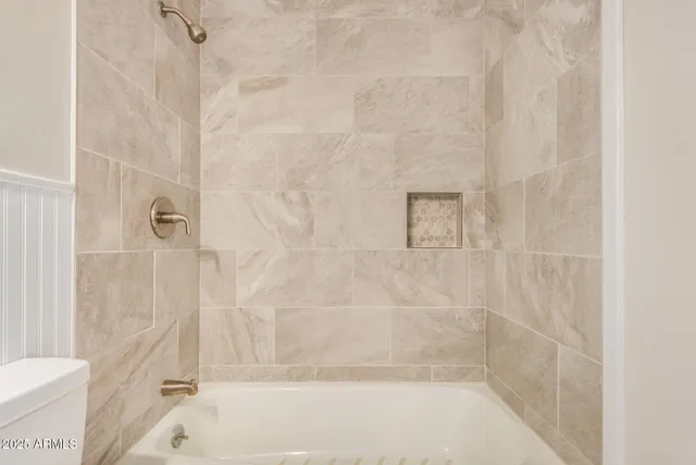 a bathroom with a shower and a bathtub