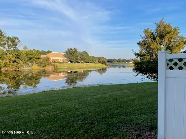 a view of a lake with houses in the back