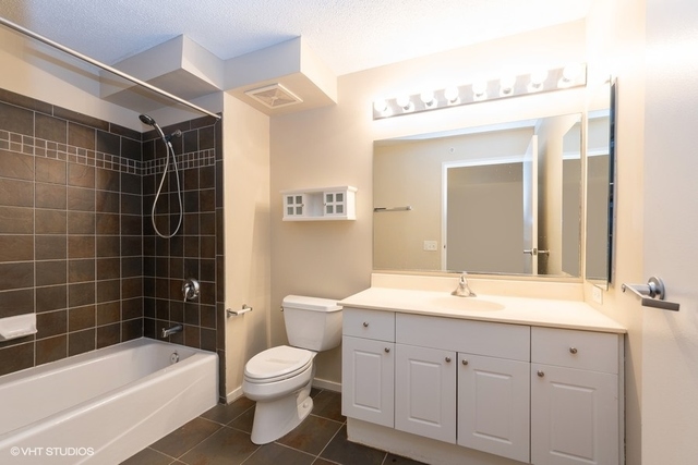800 Elgin Road, Unit 519 Evanston, IL 60201 - Photo 8 of 17 a bathroom with a sink a toilet and shower