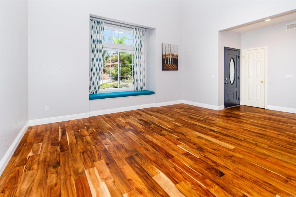 24427 Novato Place Ramona, CA 92065 - Photo 14 of 54 a view of an empty room with wooden floor and a window
