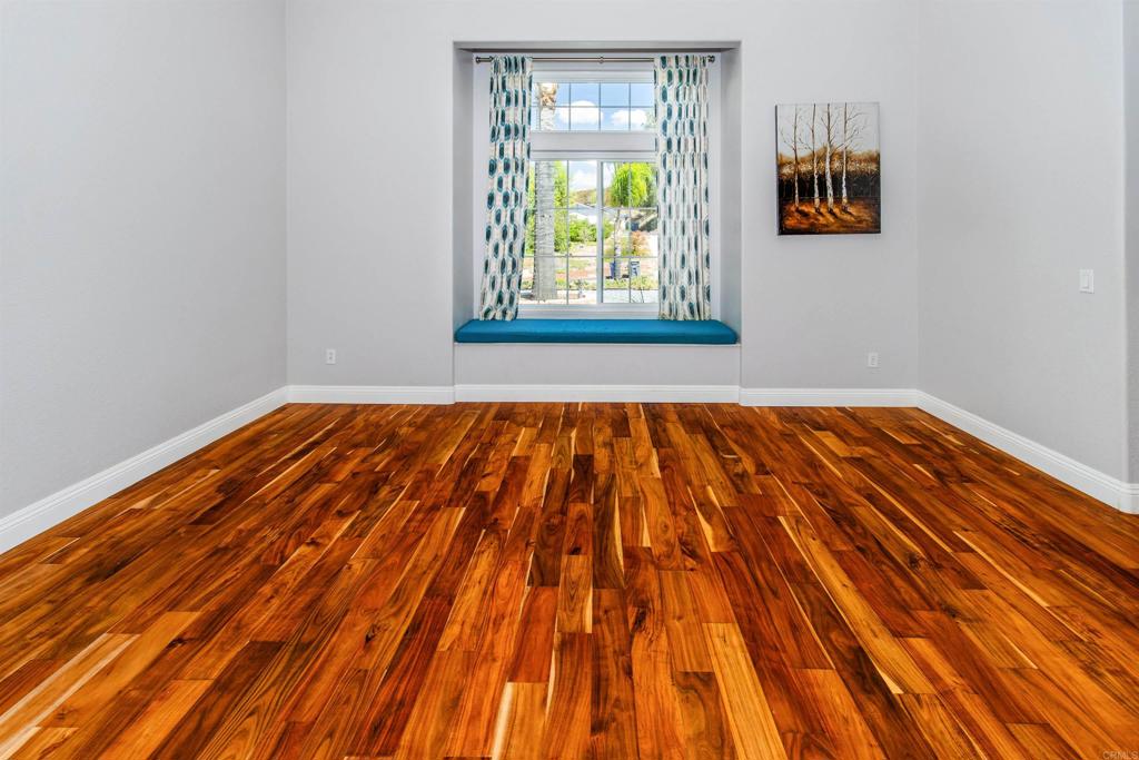 24427 Novato Place Ramona, CA 92065 - Photo 16 of 54 a view of an empty room with wooden floor and a window