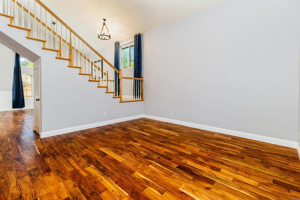 24427 Novato Place Ramona, CA 92065 - Photo 18 of 54 a view of an empty room with wooden floor and fan