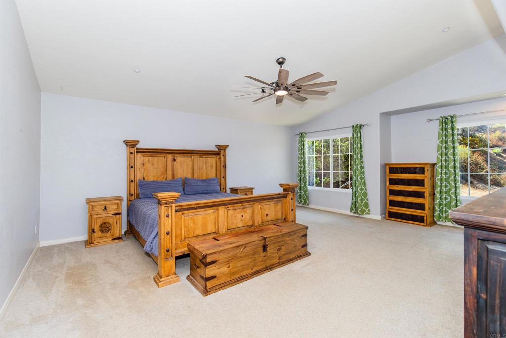 24427 Novato Place Ramona, CA 92065 - Photo 32 of 54 a living room with furniture and a flat screen tv