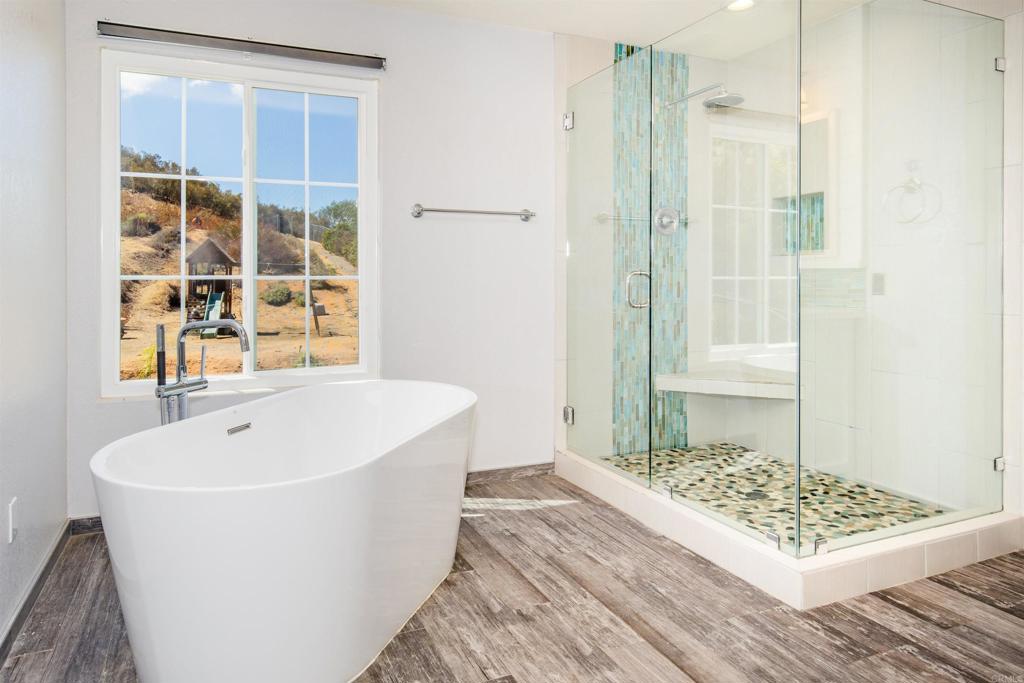 24427 Novato Place Ramona, CA 92065 - Photo 39 of 54 a spacious bathroom with a bathtub and shower