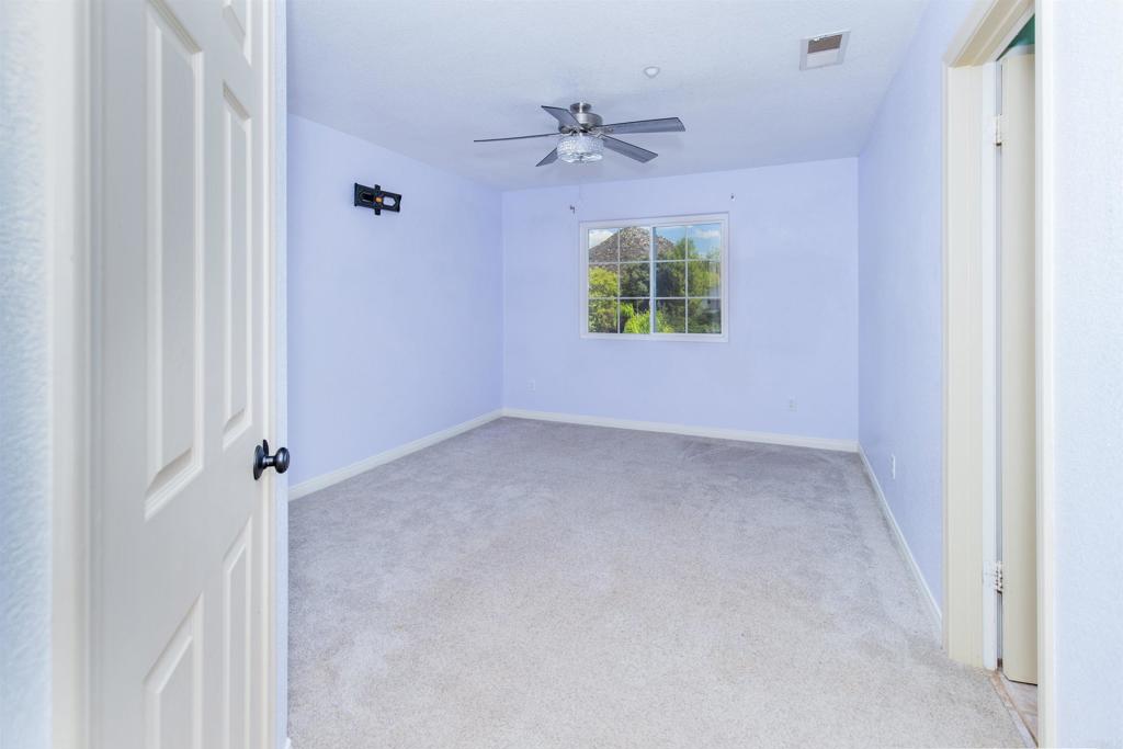 24427 Novato Place Ramona, CA 92065 - Photo 42 of 54 an empty room with windows and entrance