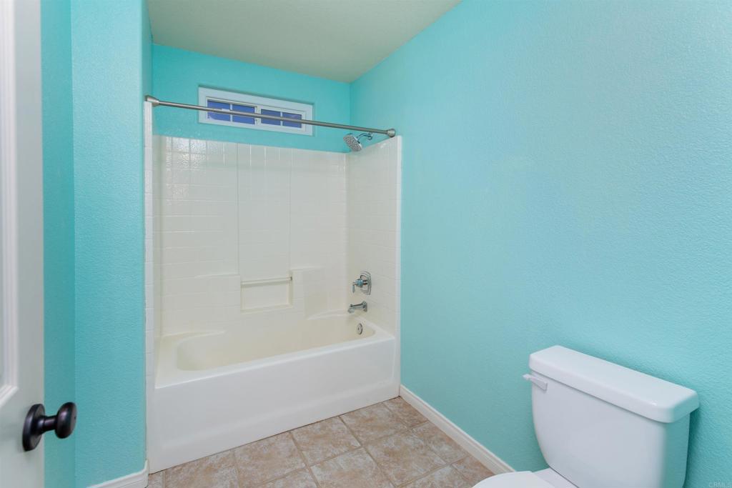 24427 Novato Place Ramona, CA 92065 - Photo 44 of 54 a bathroom with a toilet and a bathtub