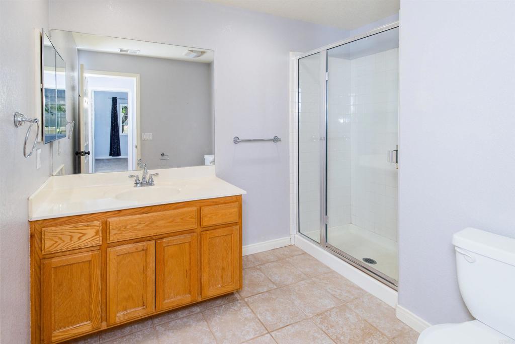 24427 Novato Place Ramona, CA 92065 - Photo 49 of 54 a bathroom with a sink a toilet and shower
