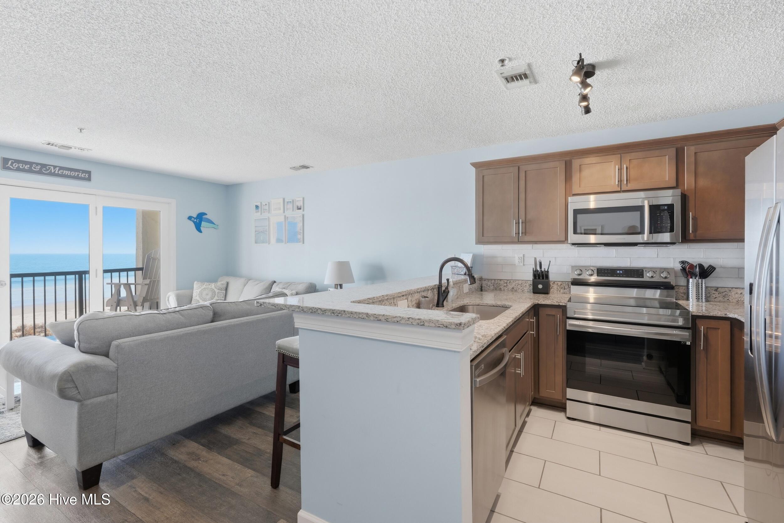 790 New River Inlet Road, Unit 114A North Topsail Beach, NC 28460 - Photo 6 of 37 17_kitchen living