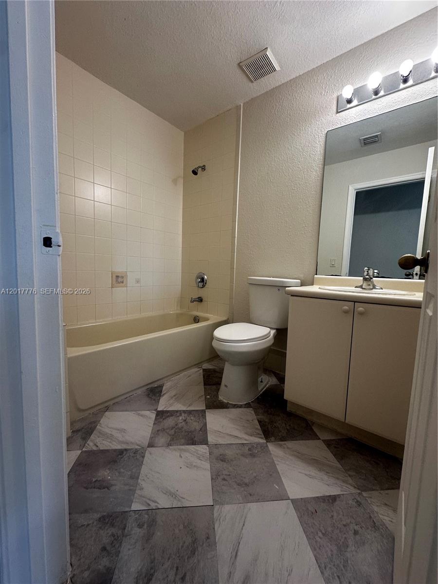 2907 Southeast 15th Road, Unit 67 Homestead, FL 33035 - Photo 19 of 25 a bathroom with a sink toilet and shower