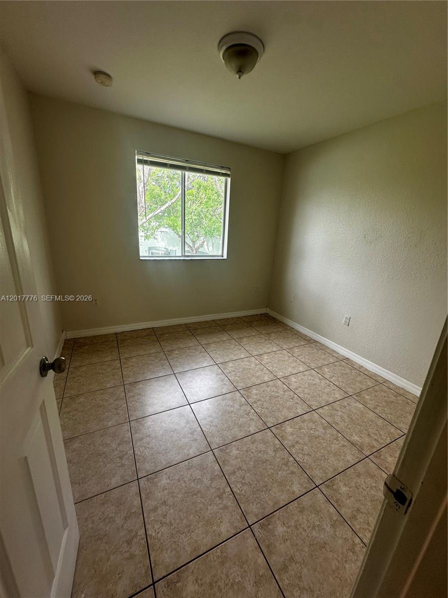 2907 Southeast 15th Road, Unit 67 Homestead, FL 33035 - Photo 20 of 25 an empty room with a empty space and window