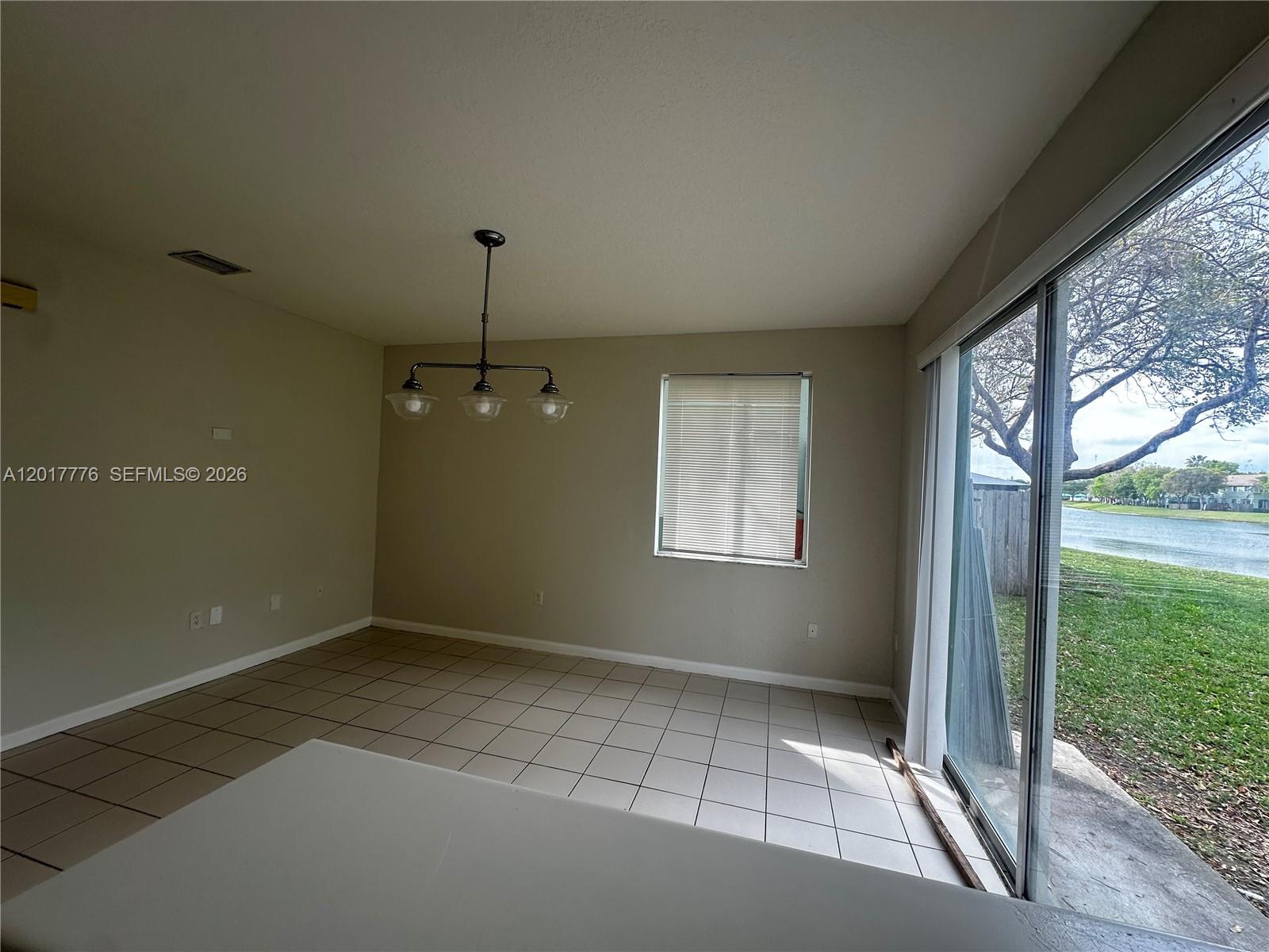 2907 Southeast 15th Road, Unit 67 Homestead, FL 33035 - Photo 2 of 25 a view of an empty room with a window