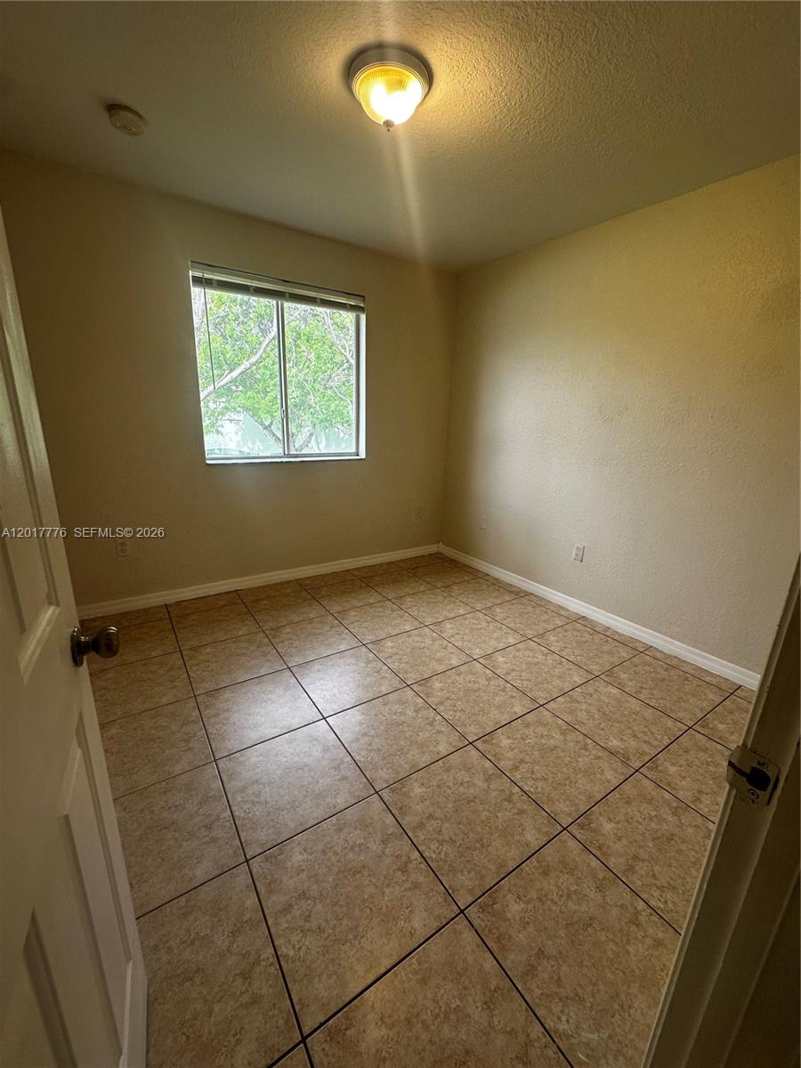 2907 Southeast 15th Road, Unit 67 Homestead, FL 33035 - Photo 21 of 25 a view of an empty room and window