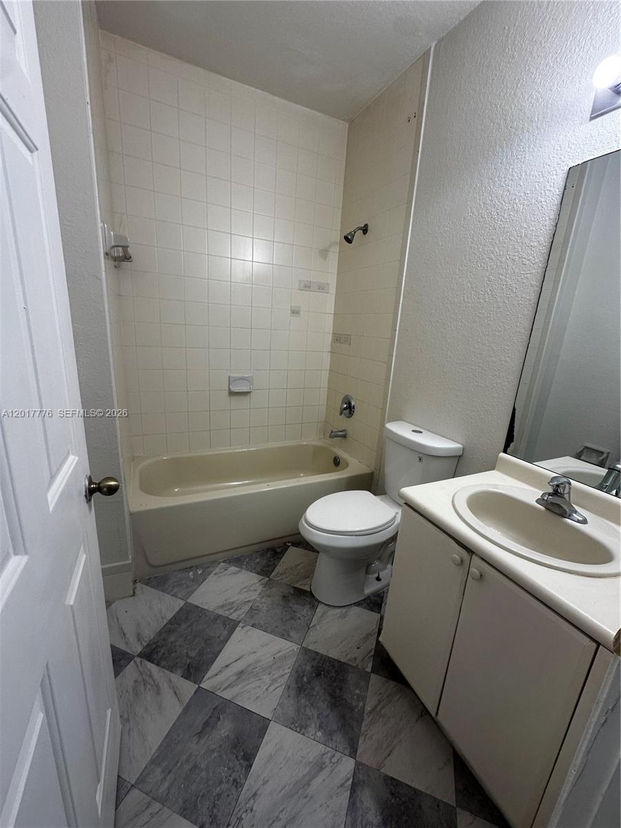 2907 Southeast 15th Road, Unit 67 Homestead, FL 33035 - Photo 7 of 25 a bathroom with a sink toilet and shower