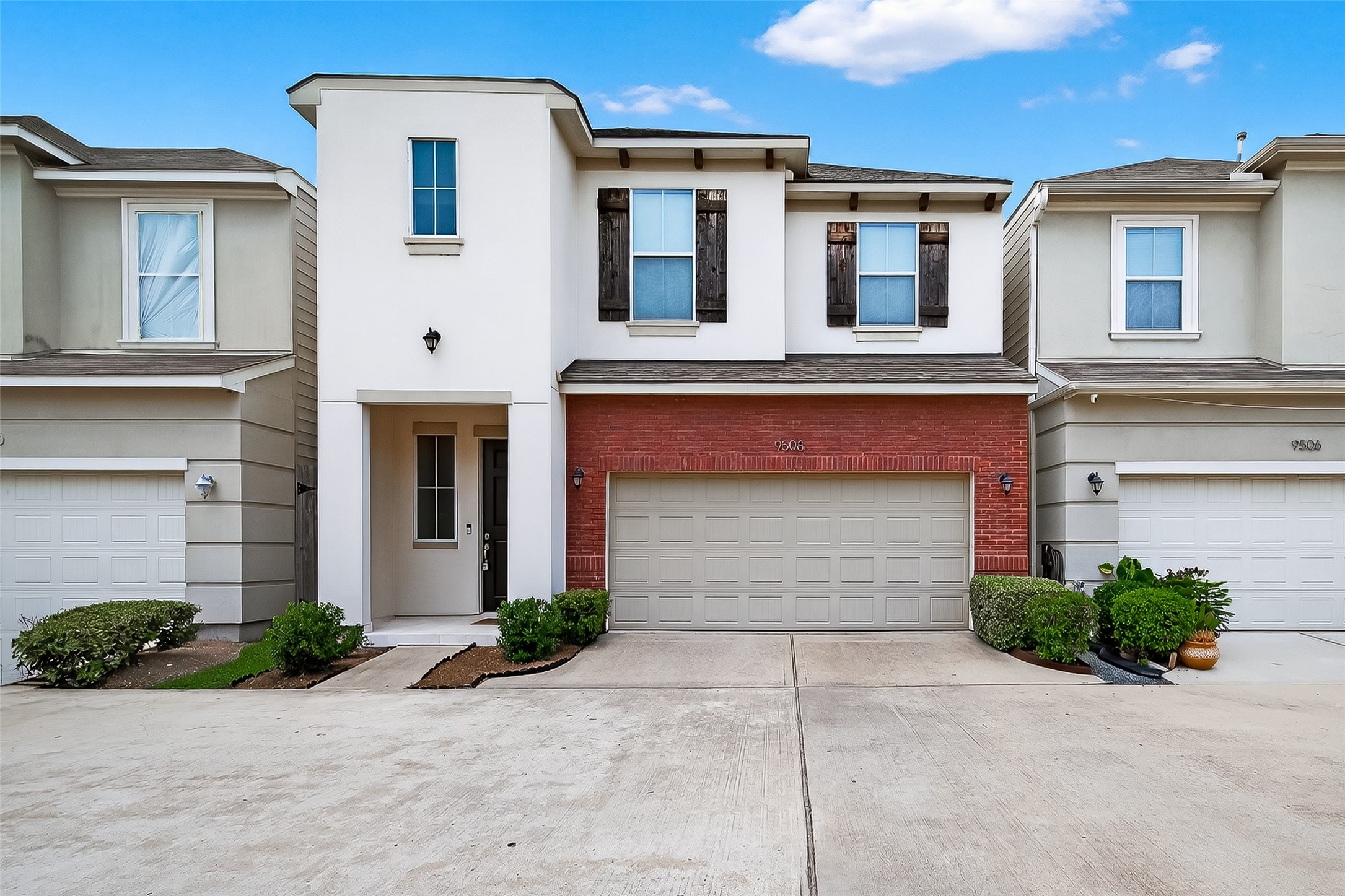 9508 Cedarpost Square Street Houston, TX 77055 - Photo 1 of 30 a front view of a house with a yard and garage