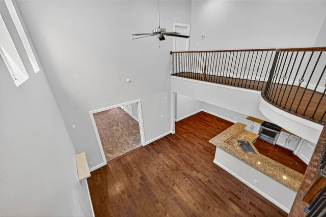 a view of an empty room with a window and a ceiling fan