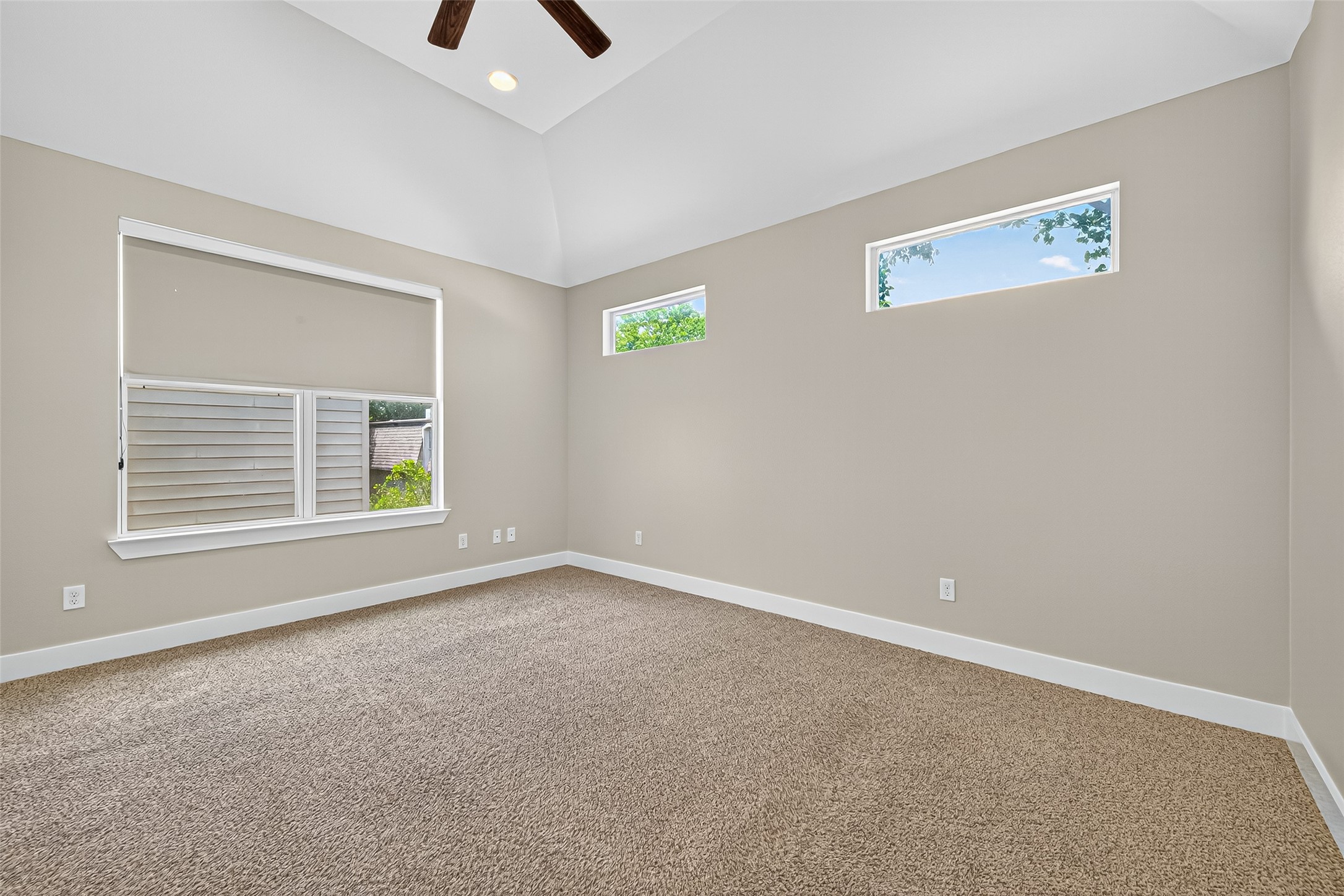 9508 Cedarpost Square Street Houston, TX 77055 - Photo 15 of 30 a view of an empty room with a window and a ceiling fan