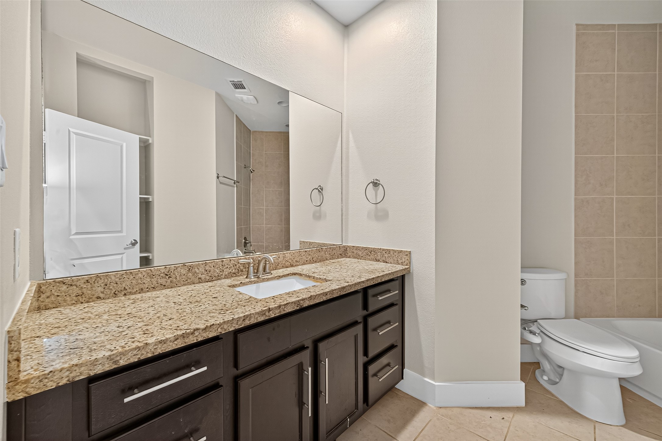 9508 Cedarpost Square Street Houston, TX 77055 - Photo 20 of 30 a bathroom with a granite countertop sink and a mirror