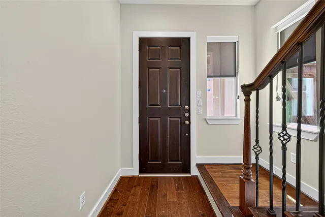 a view of front door with wooden floor
