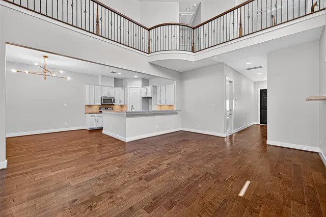a view of a kitchen with wooden floor and staircase