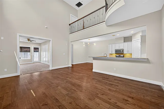 a view of a kitchen with furniture and wooden floor