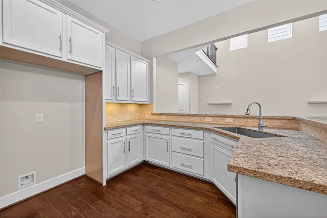 a kitchen with granite countertop cabinets and sink