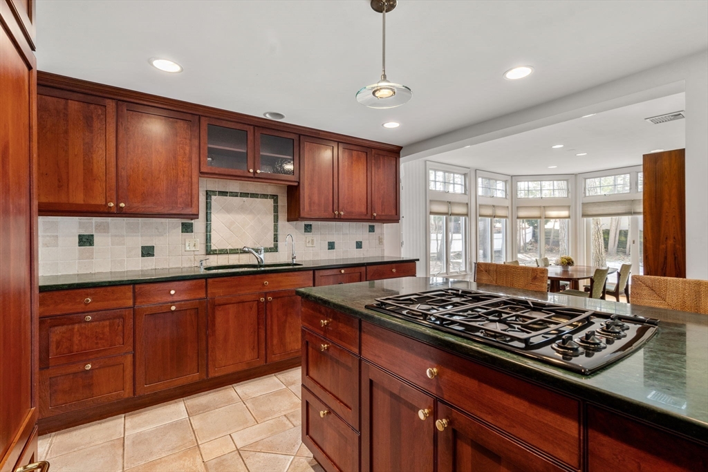 6 Earle Road Wellesley, MA 02481 - Photo 14 of 33 a kitchen with wooden cabinets and a stove top oven