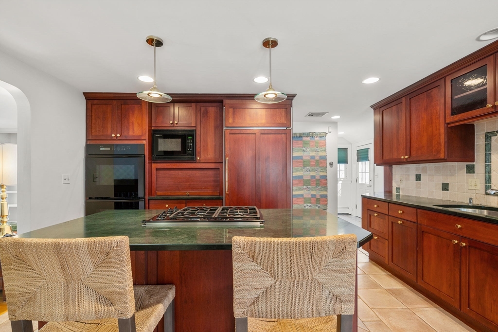 6 Earle Road Wellesley, MA 02481 - Photo 16 of 33 a kitchen with granite countertop a stove and a wooden floors