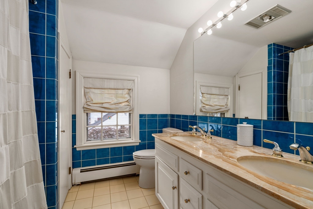 6 Earle Road Wellesley, MA 02481 - Photo 20 of 33 a bathroom with a sink a vanity and a mirror