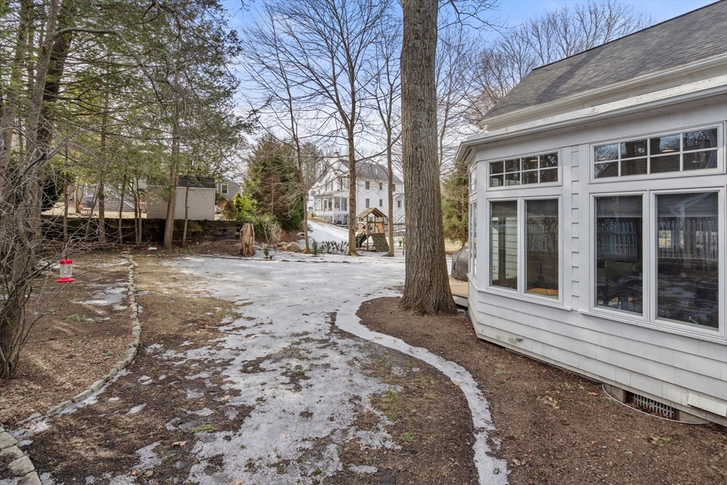 6 Earle Road Wellesley, MA 02481 - Photo 29 of 33 a backyard of a house with large trees and outdoor seating