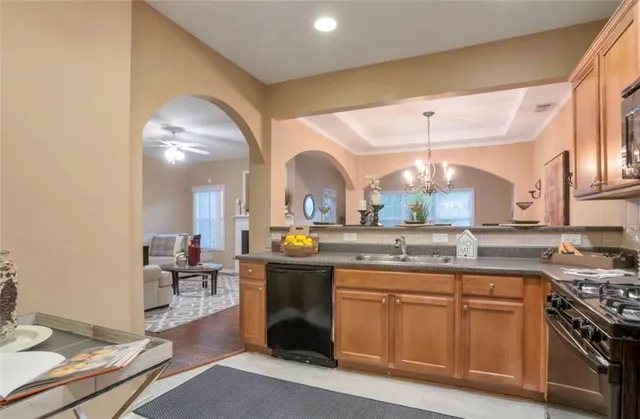 a kitchen with stainless steel appliances granite countertop a stove and a sink