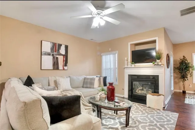 a living room with furniture a fireplace and a flat screen tv