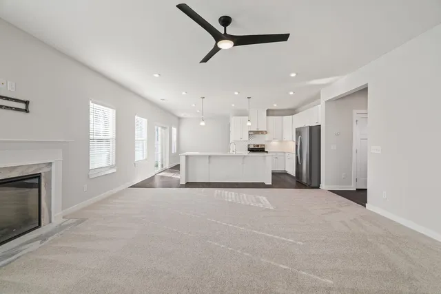 a view of a kitchen with a sink and a fireplace