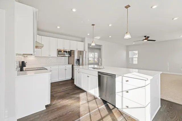 a kitchen with white cabinets and white appliances