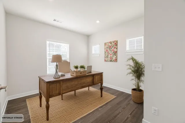 a view of a workspace with furniture and a potted plant