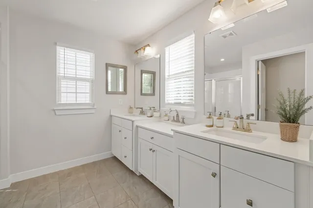 a bathroom with 2 sink tub and a mirror